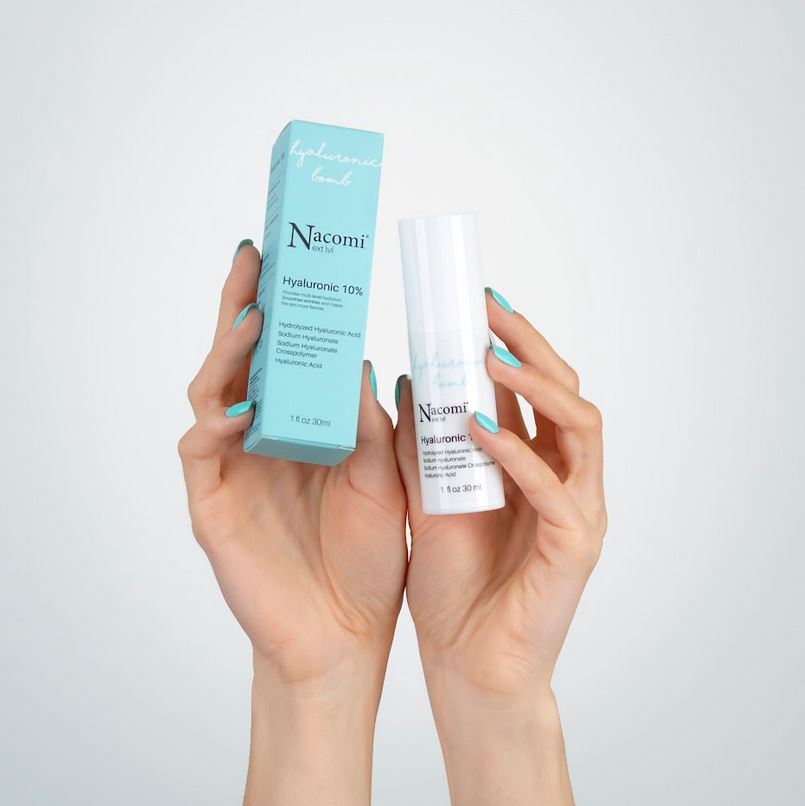 Ragazza sostiene confezione siero viso idratante Nacomi Next Lvl Hyaluronic Bomb 10% con acido ialuronico,.
